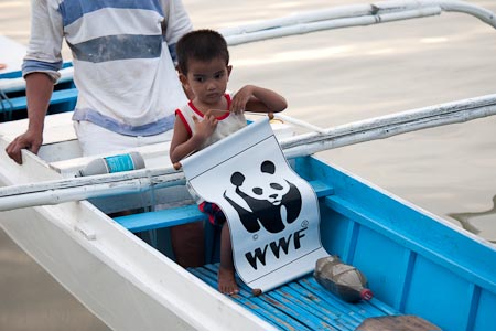 Ely's son holding a WWF banner in Malampaya Sound. 