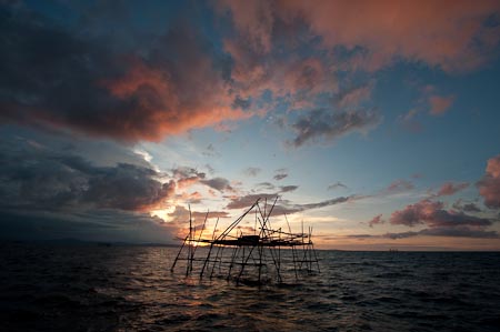 Sunset shot of a "bagang" FAD or fish attracting devise to catch anchovies at night using kerosine lamps