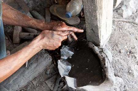 A blacksmiths' hands getting a wash from a poor old tridacna basin