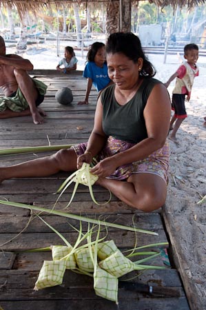Also from Runduma, this woman weaves a rice container made from young coconut leaves