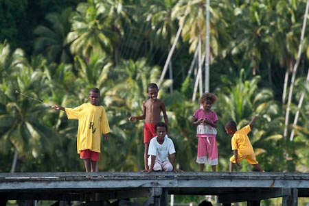 Starting young, these Papuan kids go fishing everyday from the jetty