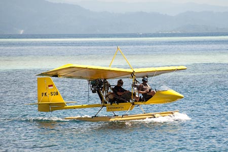 Beautiful ultra-light float plane ready for take off. Hat, check. Goggles, check. Fuel, check. Camera, check. All set to fly the kingdom of the 4 kings