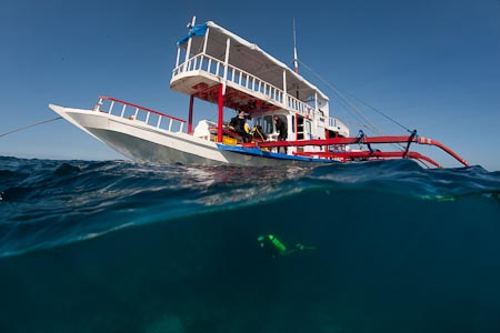 The colors of Asia comes out with this bright outrigger boat turned liveaboard in Apo Reef
