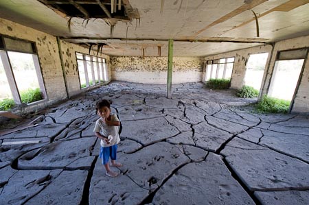 An even sadder prospect is this high school which also has a meter deep mud encased inside the classrooms
