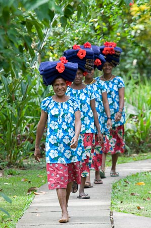 Local Papuan ladies who make sure our rooms are spic and span carry towels in their heads for the next bungalow