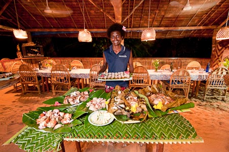 Mama Rachel proudly shows us the sumptuous meal we were about to have in Lissenung Island Resort dining area