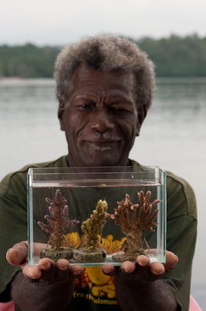 Erik Koti holds some of his coral fragments