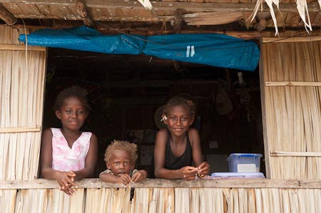 Village life couldn't be more charming than seeing these young girls look out their kitchen window
