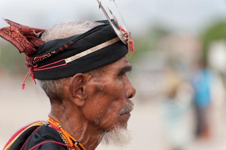 A traditional headgear called kaibauk adorn this man's head as he performs a dance in the side street of Comoro