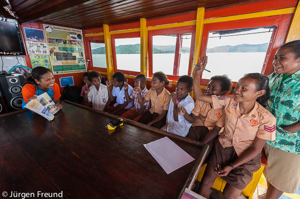 Vero animately talks about marine life to Local Papuan kids onboard Gurano Bintang.