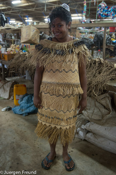 Young Fijian lass modelling a Kuta reed wedding dress in the Labasa market.