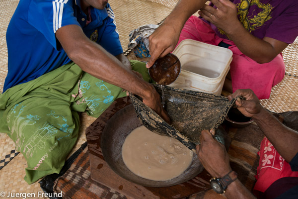 Mixing and sieving water and pounded kava through a cotton cloth.