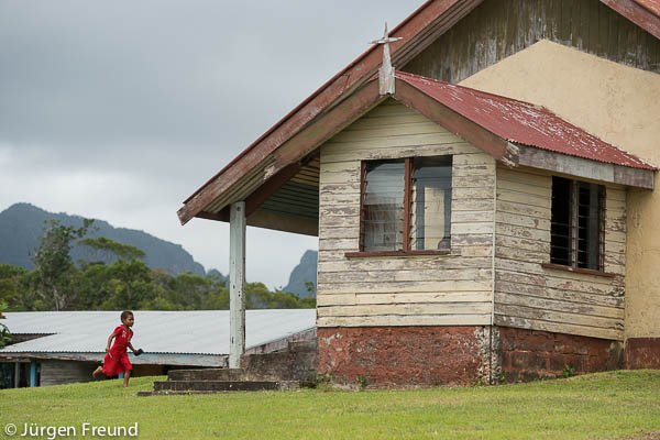Fijian girl runs to the community Methodist Church for First Sunday service.