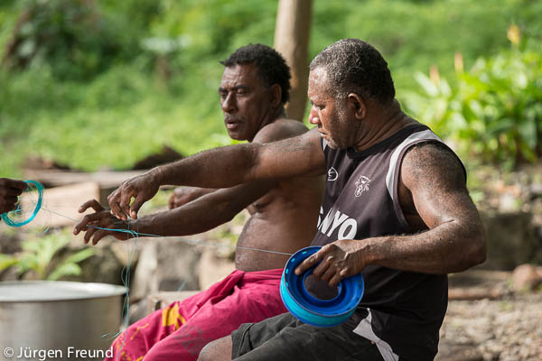 Fijian village men from Kia island preparing their fishing lines.