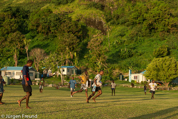 Kia Island menfolk of Ligau Village play rugby natural running with bare feet on the beautiful school fields of Kia Island