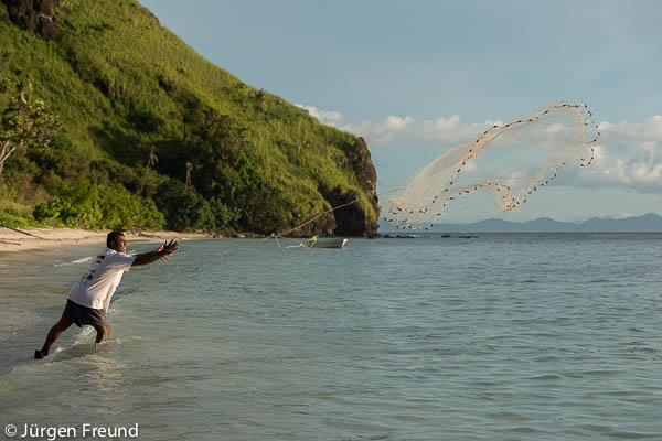 Akuila Tutora throws a cast net to catch bait fish locally called daniba by the shore. 