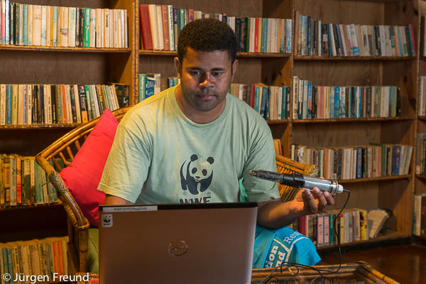 Laitia Tamata of WWF South Pacific in the library of Nukubati Island Resort downloading the data from the retrieved data logger that spent a year underwater in the Great sea Reef loading temperature information.