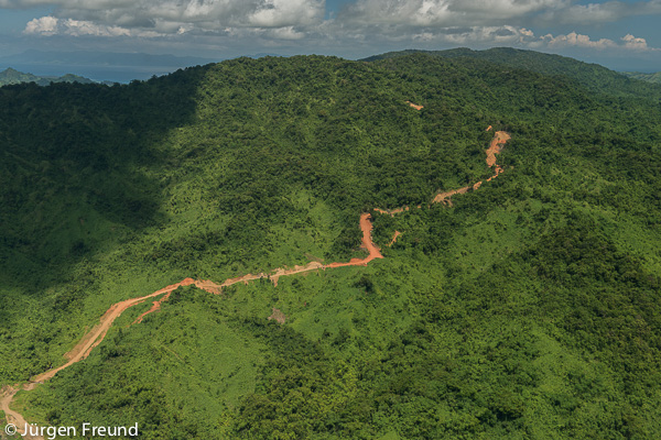 Aerial of the mountainous range of the Northern Division with a dirt road cutting through it.