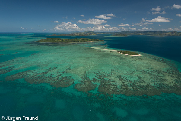 Aerial of small Katawaqa Island which is a turtle sanctuary and Kavewa Island Village.